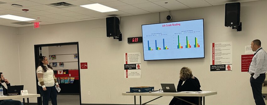 Amboy Junior High School teacher Yvonne Vicks, standing left, and AJHS Principal Andrew Full, standing right, present AJHS test results to the Amboy School Board on Thursday, April 18.