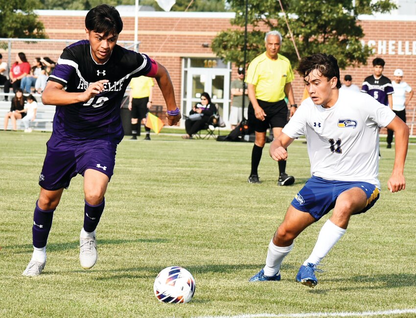 Senior Bryan Garcia races Johnsburg's Blake Bowers for the ball during the Rochelle Hub varsity soccer match against Johnsburg on Monday.