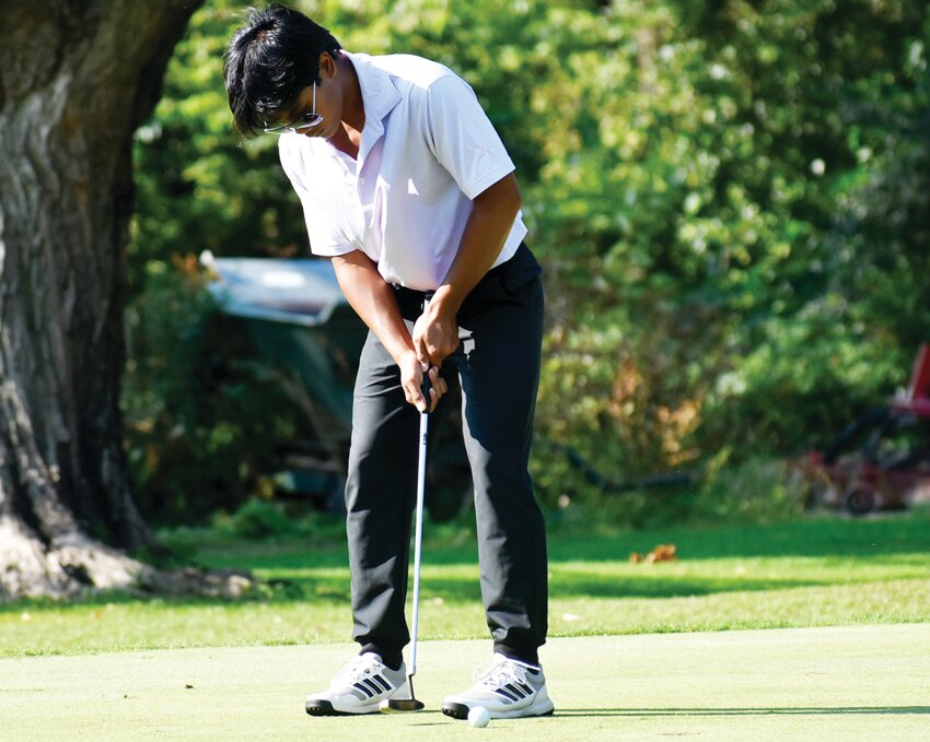 Senior Chris Hickey drains a putt during the Rochelle Hub varsity golf match against Sycamore on Tuesday.