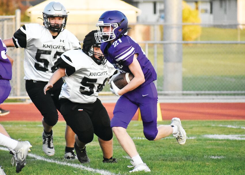 Luke Chadwick beats two defenders up the middle during the Rochelle Hub freshman football game against Kaneland on Friday.