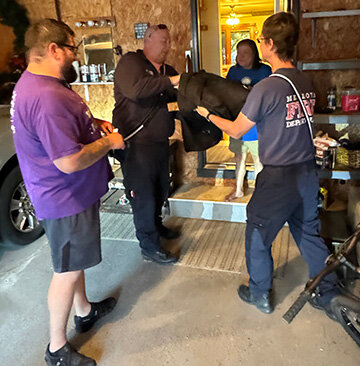 For Fire Prevention Month in October and Fire Prevention Week (Oct. 6-12), the Mendota Fire Department gassed up a fire truck and an ambulance and delivered food for Pizzas by Marchelloni on Oct. 9 for smoke detector awareness. Marchelloni’s General Manager Nick Arteaga, left, and MFD Firefighters and Paramedics, Lonny Eisenberg, center, and Justin Setchell provide a pizza to a happy customer. (Reporter photo by Brandon LaChance)