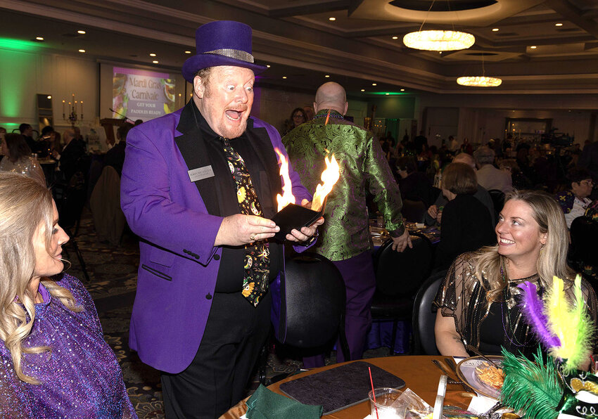 Magician John Measner of Bridgeview dazzles Mardi Gras Carnivale guests with a flaming magic trick. (Photo contributed)