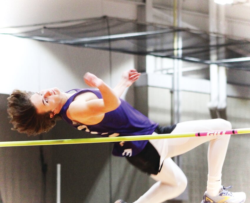 Senior Jack Tilton leaps over the bar during the high jump competition at the Byron Indoor Classic.