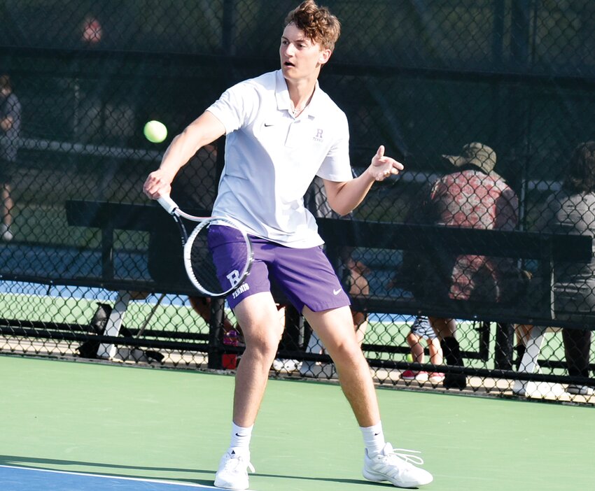 Junior Mark Green hits a backhand slice during the Rochelle Hub tennis match against Dixon on Wednesday evening.