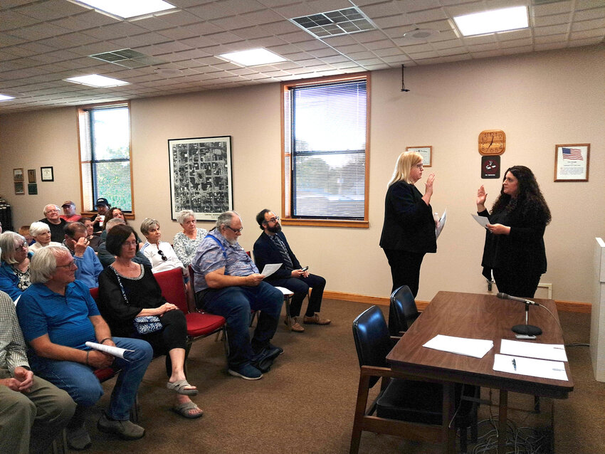 Helen Michelassi, standing left, takes her oath of office as Clinton’s new mayor from city clerk Kamren Wilford during the May 6 city council meeting.