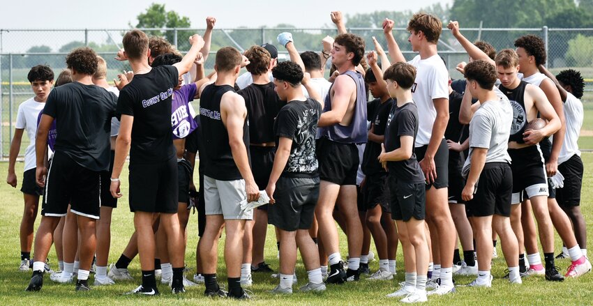 The Rochelle Hub football team huddles together after completing its skills camp on Thursday.