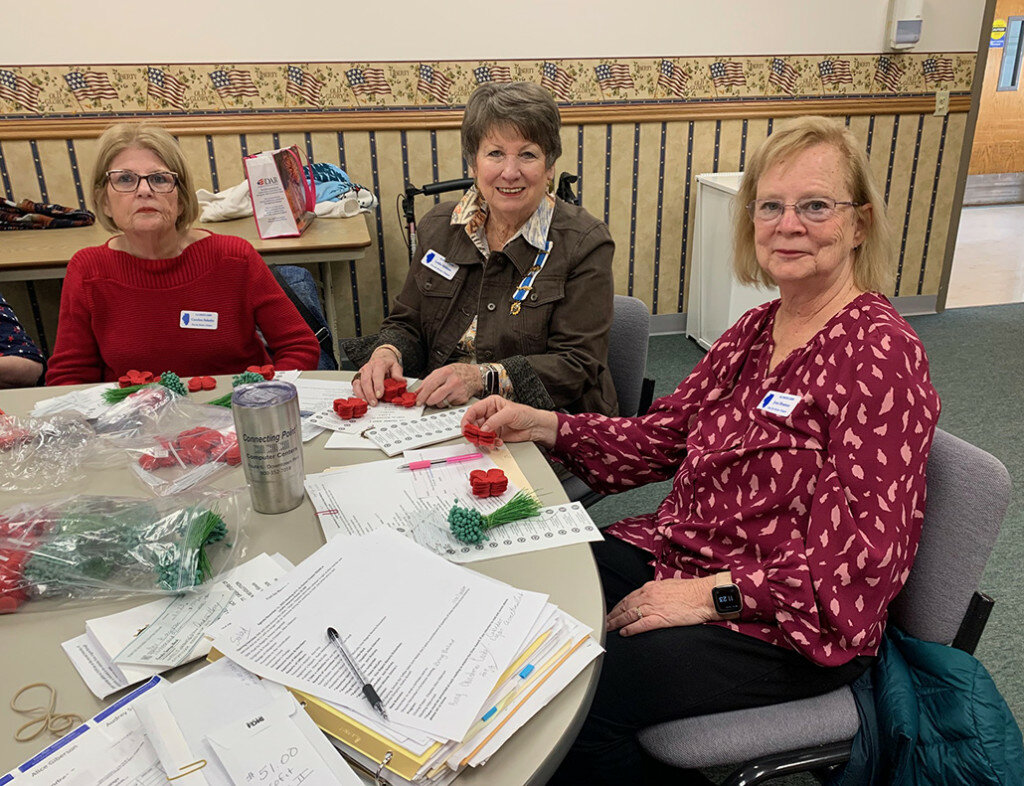 Carolyn Schultz, Leslie Althaus and Joni Bratney work on the poppy project. (Photo contributed)