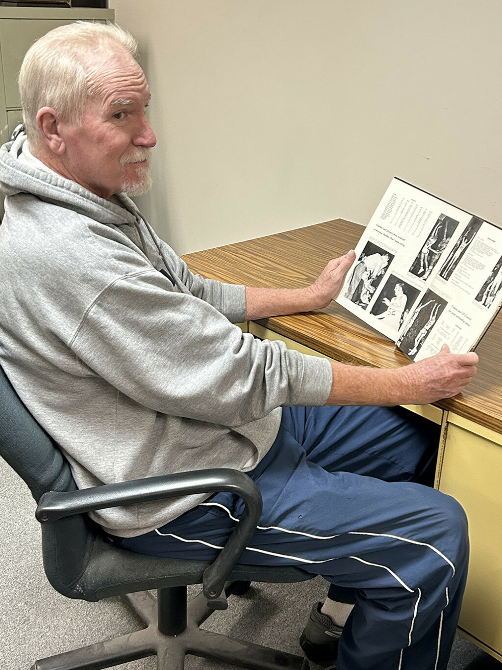 Rick Jacobs checks out the basketball pages from the 1971 Mendota High School yearbook.