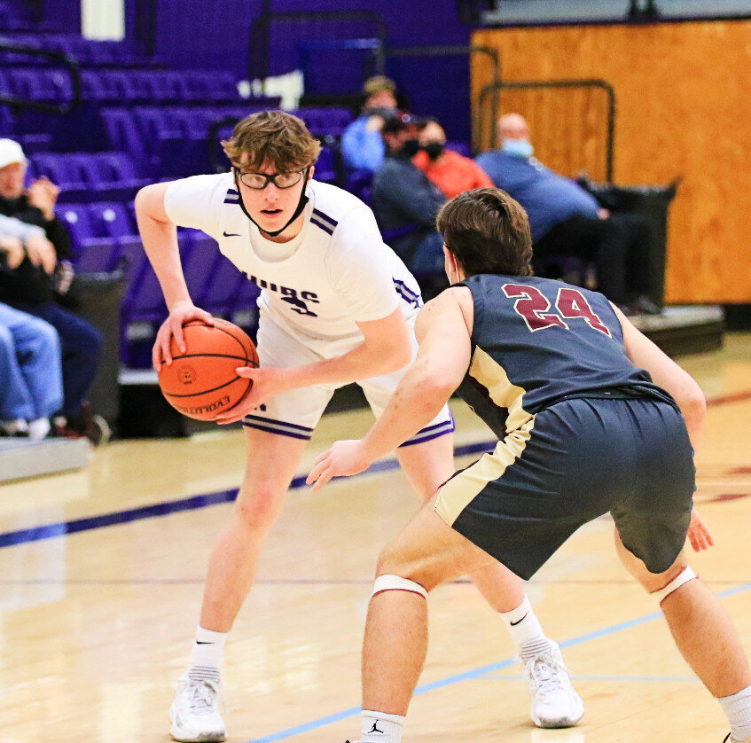 Senior Forrest Gerber stares down Morris defender Ashton Yard during the Rochelle Hub varsity basketball game against the Redskins on Saturday. (Photo by Marcy DeLille)