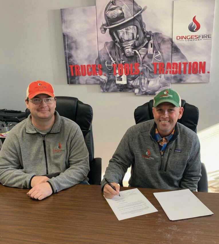 Derek Feuss (left) and Nicholas C. Dinges (right) finalize the acquisition of Fox Apparatus Repair & Maintenance by Dinges Fire Company.
Photo submitted