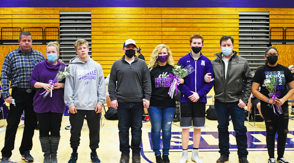 The Rochelle Hub wrestling team recognized its senior members during Tuesday’s Senior Night match against the Freeport Pretzels. Pictured above with their families are seniors Caleb Nadig, Matt Eyster and team manager Anayancy Lara. (Photo by Russell Hodges)
