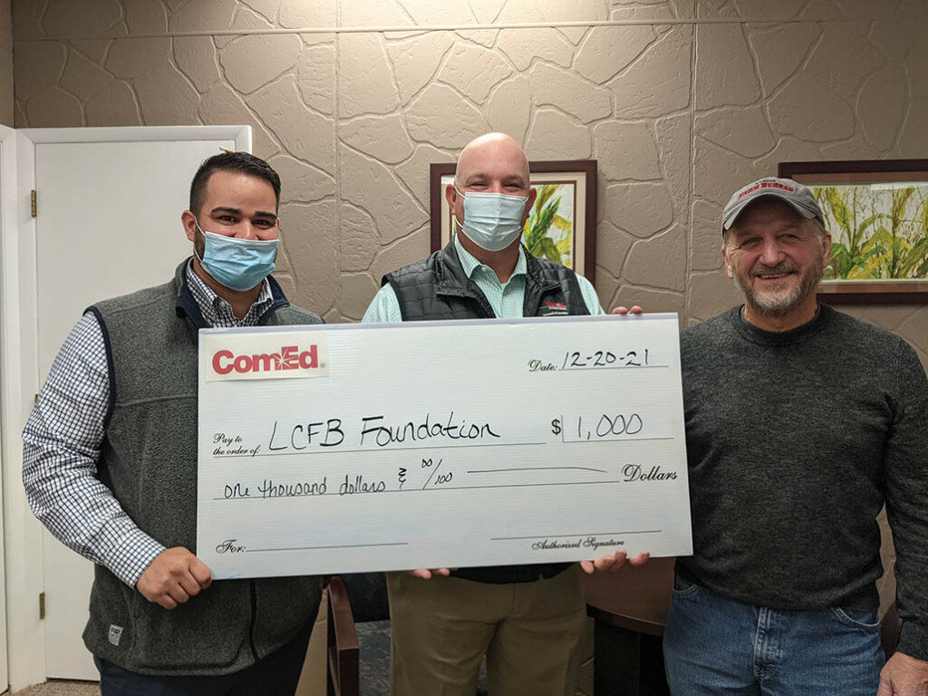 Pictured are Nick Escobar, ComEd External Affairs Manager (left), Thomas Przytulski, ComEd State and Governmental Affairs Manager (center) present Larry Hummel, Lee County Farm Bureau Foundation President (right) with the contribution. 
Photo submitted
