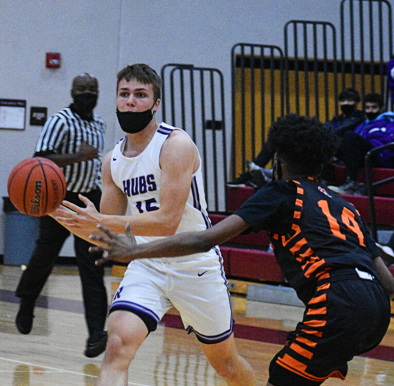 Senior Tanner Lager looks to make a pass during the Rochelle Hub varsity basketball game against Freeport on Wednesday. (Photo by Russell Hodges)