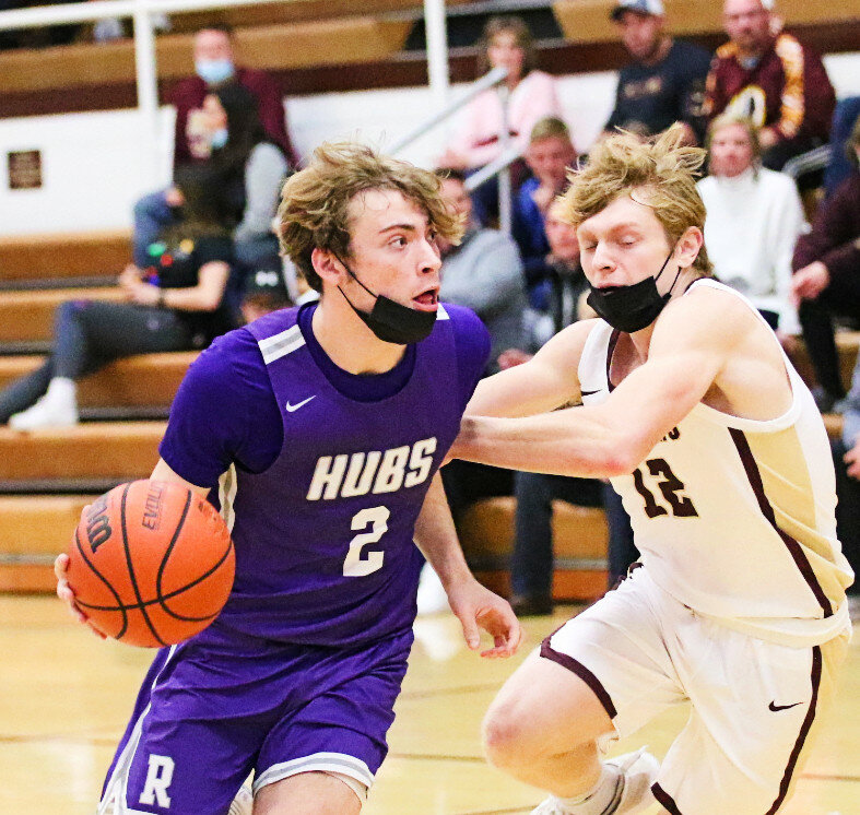 Senior Noah Brown drives around Morris defender Cameron Hatcher during the Rochelle Hub varsity basketball game Friday evening. Brown scored 21 points to lead the Hubs over the Redskins 68-63. (Photo by Marcy DeLille)