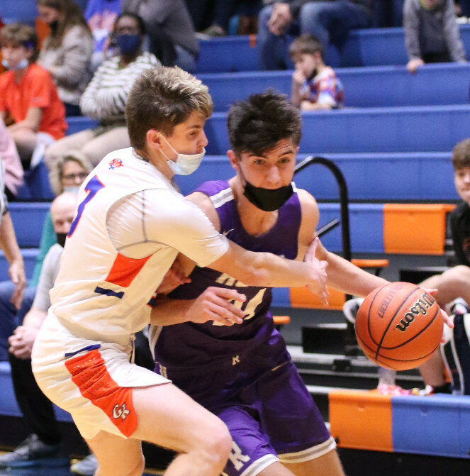 Senior Ryan Simmons (right) scored 17 points while grabbing seven rebounds and totaling three steals during the Rochelle Hub varsity basketball game against Genoa-Kington on Wednesday. (Photo by Marcy DeLille)