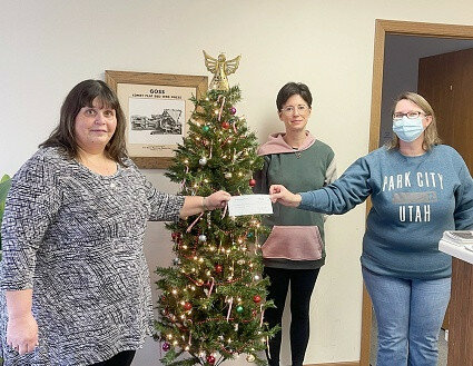 Rayanne Sester, left, executive director of Mendota Area Senior Services, accepts a check for $230 from Jennifer Robinson, right, and Jamie Stanford, both of The Mendota Reporter. (Reporter photo)