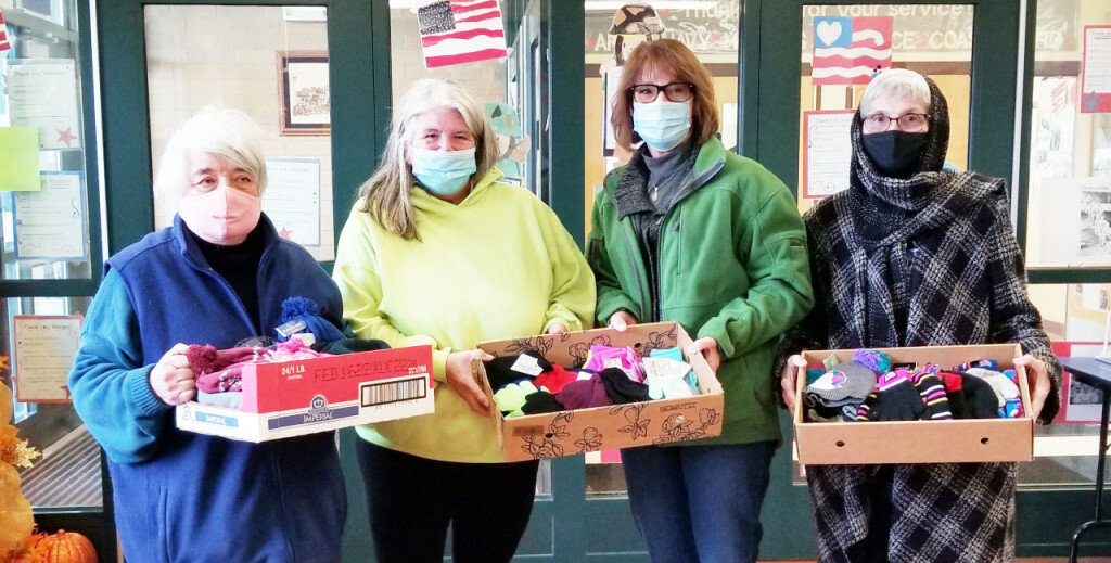 OWC members present winter hats and gloves for students at Lincoln Elementary School in Rochelle. Left to right: Nancy Bartels, OWC board member, Michele Gittleson, Lincoln Elementary, Jan Steward, OWC president and Sandi Chasm, OWC board member.