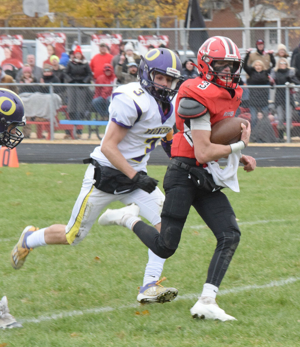 Amboy quarterback Tucker Lindenmeyer is off to the races on a long gain while Orangeville’s Brayden Cahoon tries to chase him down in the semifinals of the 8-man playoffs on Nov. 13 at the AHS field. (Reporter photo)
