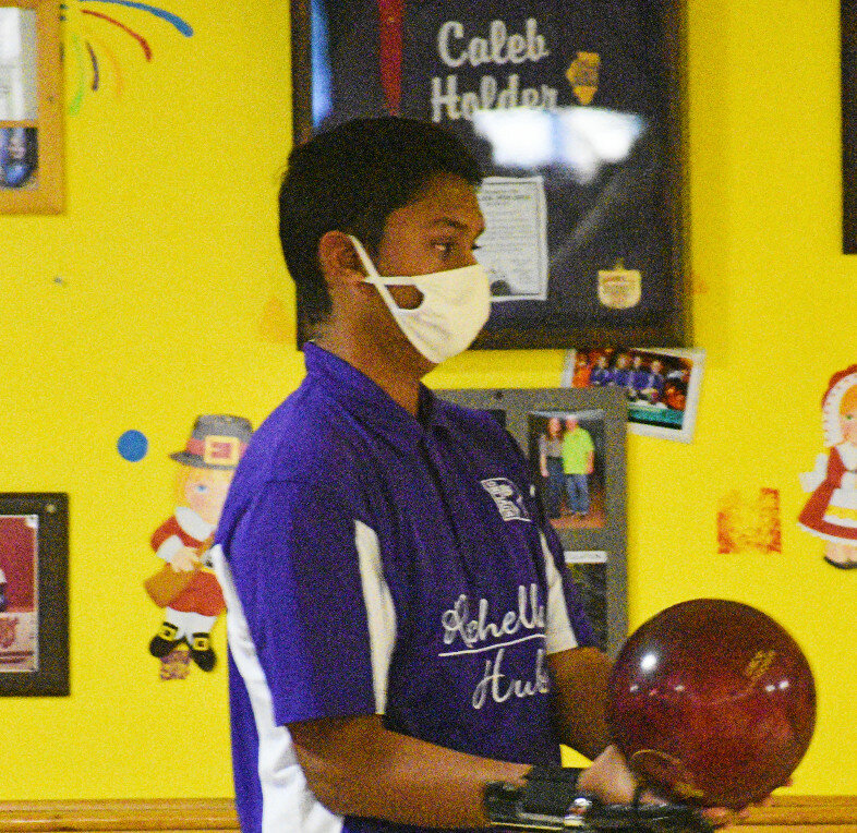 Senior Devansh Patel looks for his mark down the lane during the Rochelle Hub varsity bowling match against Sterling on Thursday. (Photo by Russell Hodges)