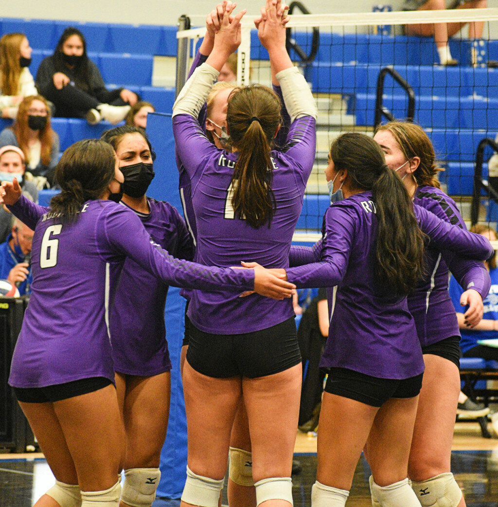 The Rochelle Lady Hub varsity volleyball team celebrates a point during the IHSA 3A Regional Semifinals against Burlington Central on Tuesday. (Photo by Russell Hodges)