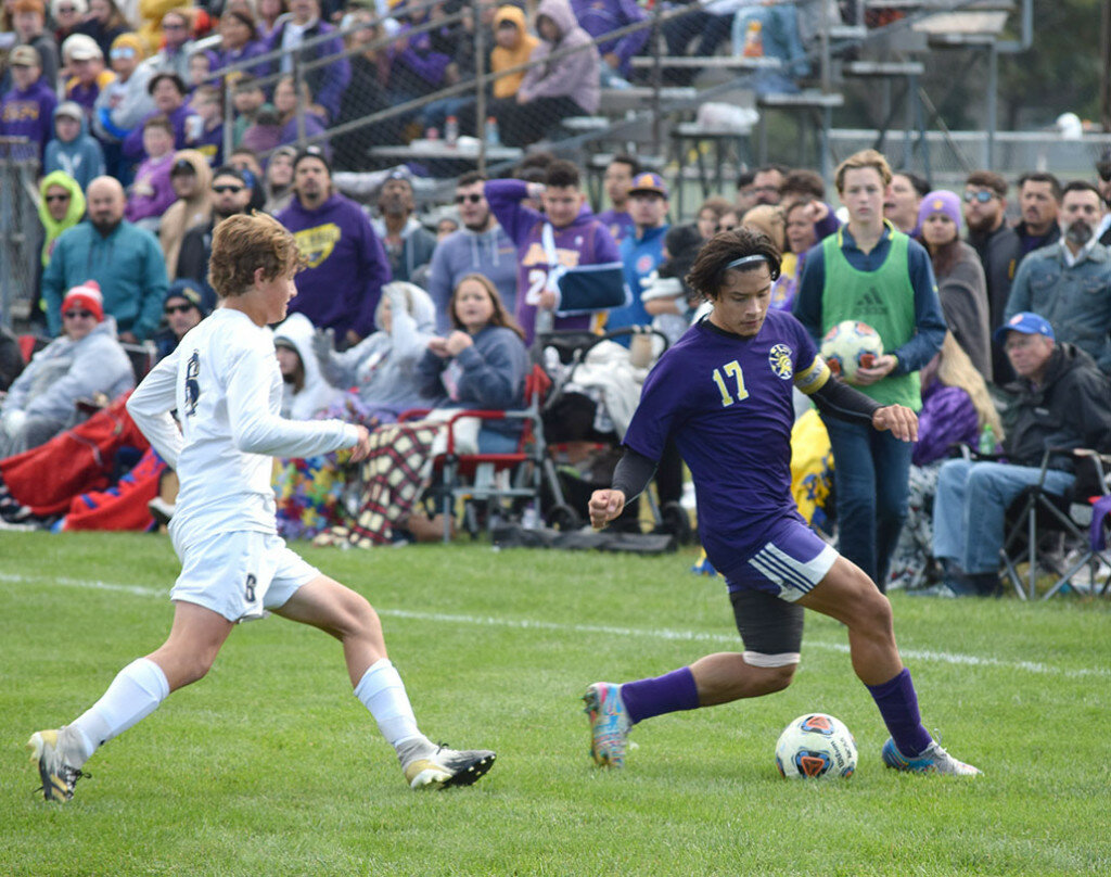 Mendota's Josue Arteaga tries to keep the ball away from Quincy Notre Dame's Rylan Fischer in the sectional championship game on Oct. 23. (Reporter photo)