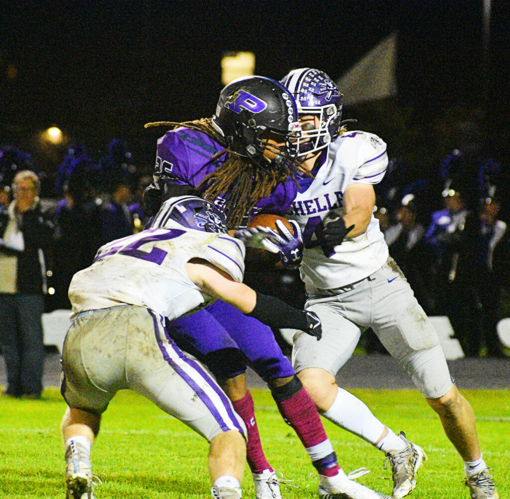 Junior Trey Taft and senior Braden Alfano combine to tackle Plano's Ray Jones during the Rochelle Hub varsity football game against the Reapers on Friday. (Photo by Russell Hodges)