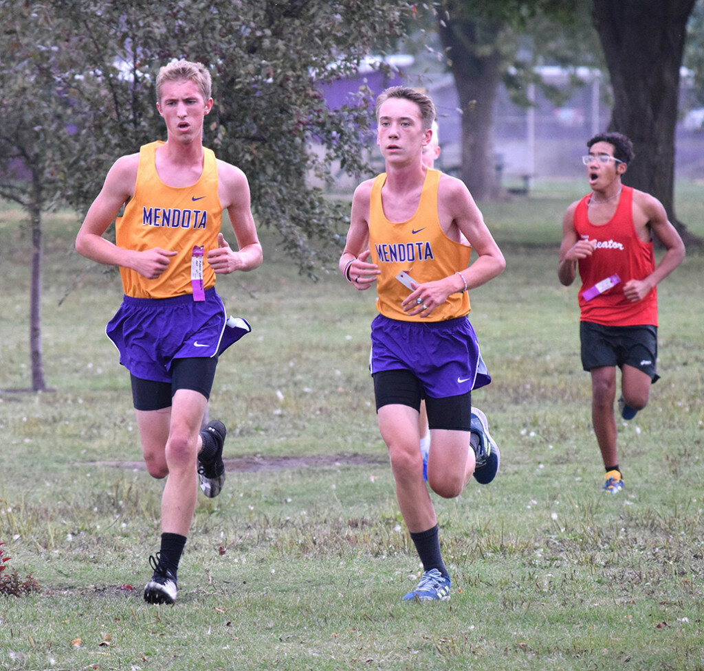 Mendota’s Andrew Stamberger, left, and Dagen Setchell are side-by-side as they motor around the lake during a home cross country meet on Oct. 6. (Reporter photo)