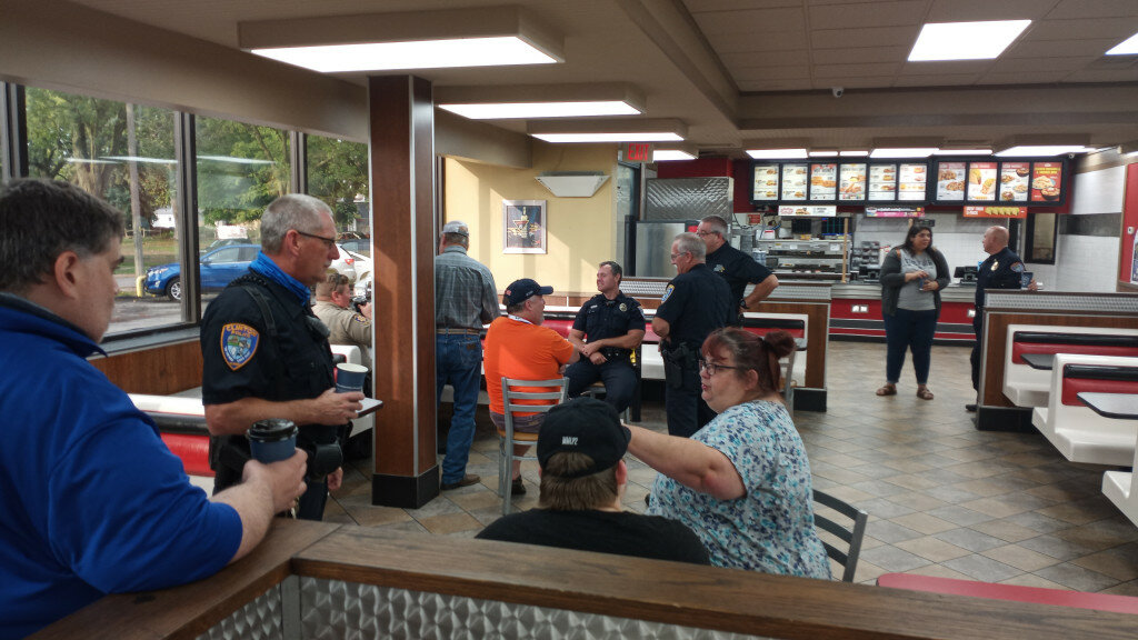 Gordon Woods / Journal — Residents stopping by Clinton Hardee's on Wednesday morning had the opportunity to mingle with local law enforcement.  Clinton Police Chief Ben Lowers, DeWitt County Sheriff Mike Walker and members of their departments enjoyed coffee with patrons from 7-9 a.m.