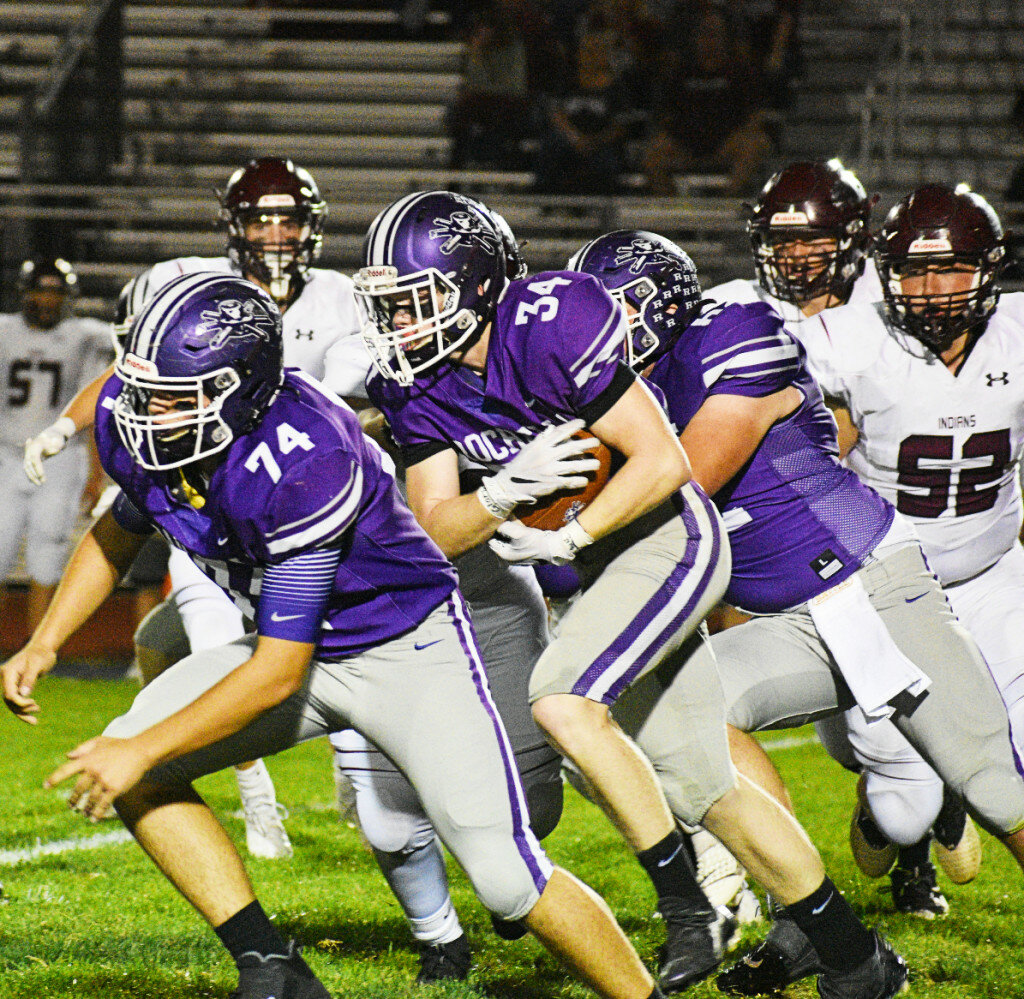 Junior Cody Stover-Cullum (middle) runs behind teammate Bradley Cooney (left) during the Rochelle Hub varsity football game against Marengo on Friday. Stover-Cullum rushed for three touchdowns in the win. (Photo by Russell Hodges)
