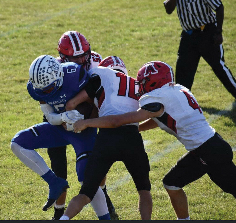 Amboy’s Caden Wittenauer (#10) Jordan Gulley (#4) Levi McKinnley (#52) take down a Milton player during the game on Saturday, Sept. 25 at Milton.
Photo courtesy of Tina Lindenmeyer