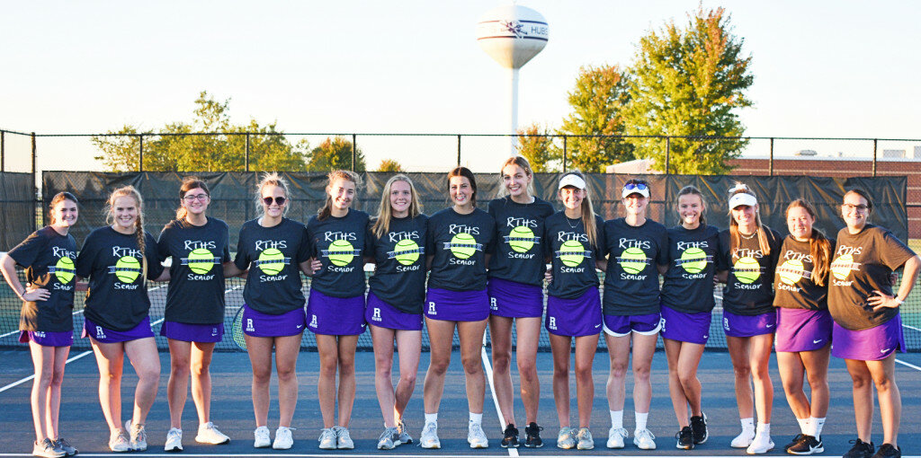 The Rochelle Lady Hub tennis team celebrates its 14 seniors during Tuesday's match with Kaneland. Above from left to right are Margaux DaCosta, Ashley Knight, Ella Seebach, Josie Lundquist, Ella McKinney, Madison Ost, Lauren Jackson, Abby Luxton, MeLisa Young, Jordin Dickey, Emma Hicks, Liberty Hayes, Megan Thompson and Hailey Miller. (Photo by Russell Hodges)