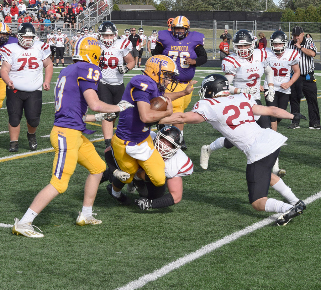 Mendota quarterback Ted Landgraf tries to shake off a Hall defender on Sept. 25 at the MHS field. (Reporter photo)