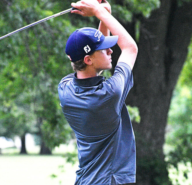 Junior Wade Smith hits an iron shot for the Rochelle Hub varsity golf team. (Photo by Russell Hodges)