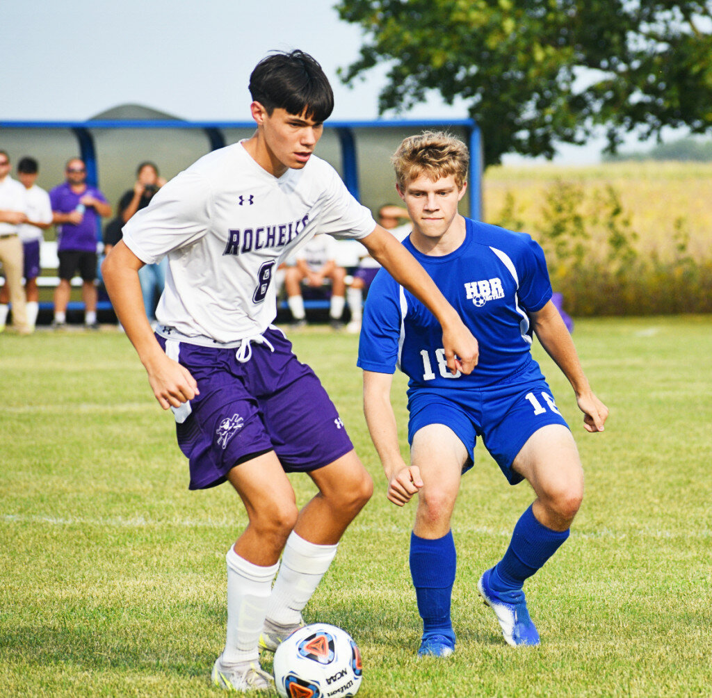 Junior Jace Whitehead battles for possession during the Rochelle Hub varsity soccer match against Hinckley-Big Rock on Monday. (Photo by Russell Hodges)