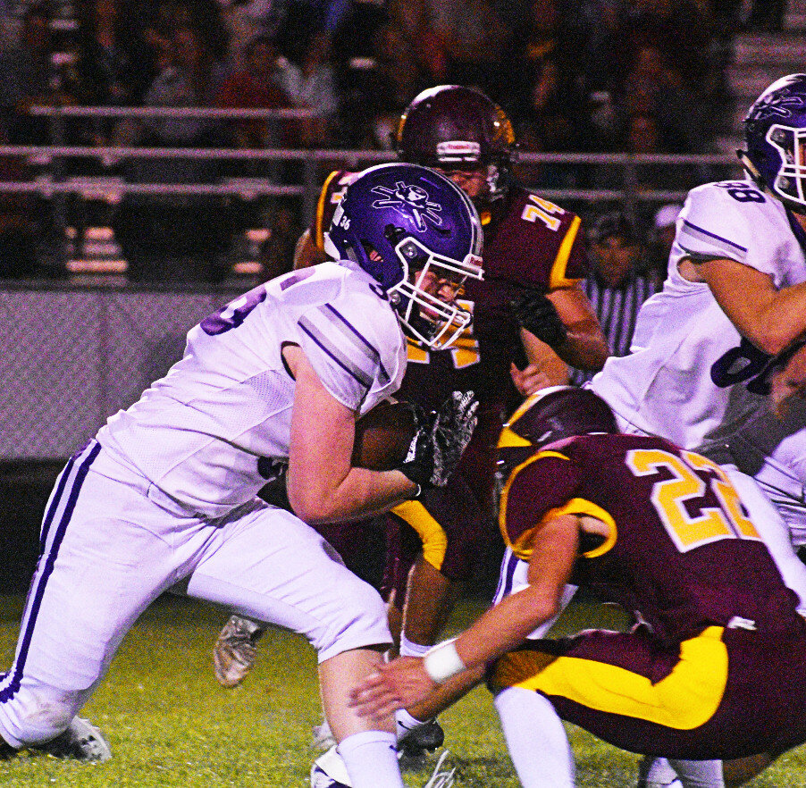 Junior Landon DeLille runs the ball up the middle during the Rochelle Hub varsity football game against Richmond-Burton on Friday. (Photo by Russell Hodges)