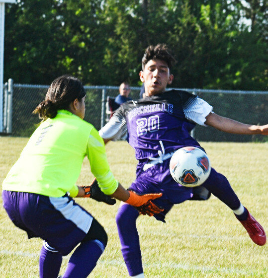 Freshman Alberto Casillas challenges the Plano goalkeeper during the Rochelle Hub varsity soccer match against the Reapers on Monday. Casillas scored one goal for the Hubs in the victory. (Photo by Russell Hodges)