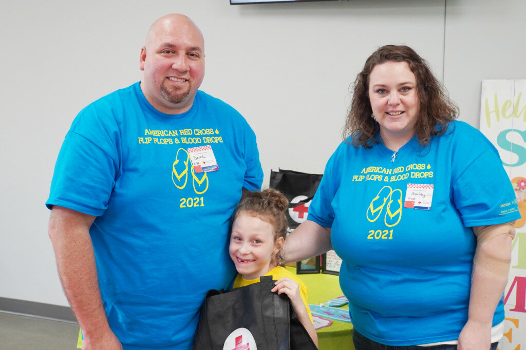 Gabrielle and Derek Troha pose for a photo with their daughter, Lana, at Monday's Flip Flops and Blood Drops blood drive.