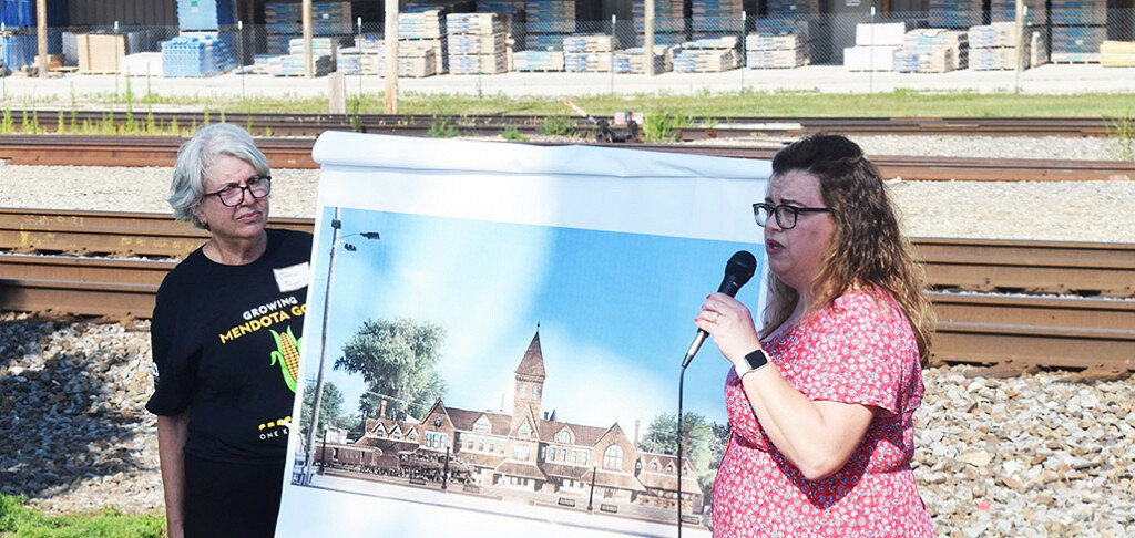 Michelle Wade, right, speaks to a gathering on Aug. 2 about a proposed mural being placed in Mendota of the old Mendota Union Depot Train Station that would be a part of the Silo Pathways Countryside Public Art Tour. Wade and her husband, Gabe, are commissioning the “Raise the Depot” project. Chris Coughlin, left, is the chair of the Silo Pathways Legacy Project through NCI ARTworks. (Reporter photo)