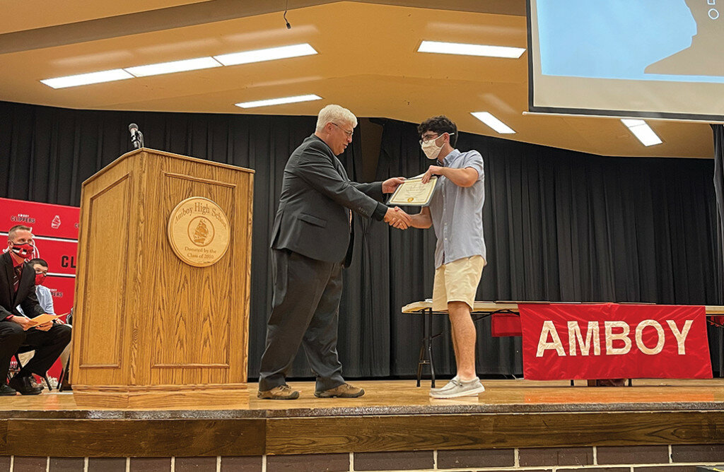 Mike Hickey of The First National Bank in Amboy presents the 2021 Student of the Year award to Nicholas Tarr during the Amboy High School Honors Night on Thursday.
Tonja Greenfield/Amboy News