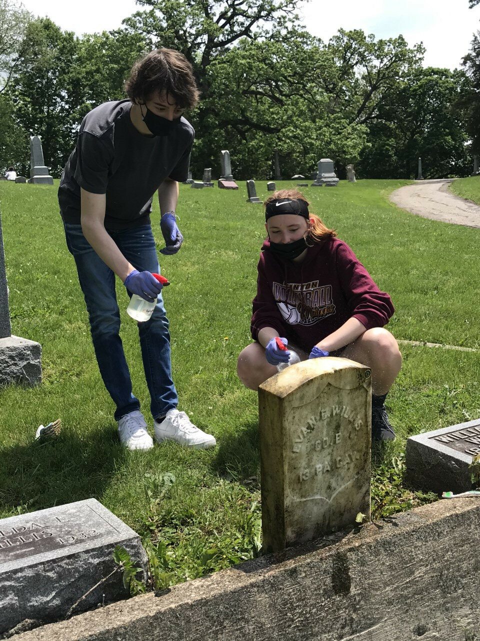 Katy O’Grady-Pyne / Journal — 
Aiden Peterson and Brielle Morrison worked to clean the headstone of veteran Evan Willis who passed away in an automobile accident near Weldon Springs in 1929.