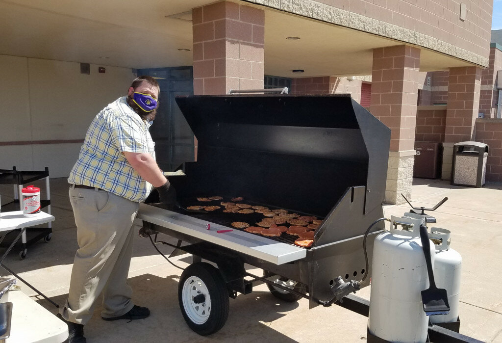 Matt Meyer grills pork chops at Mendota High School. (Photo contributed)