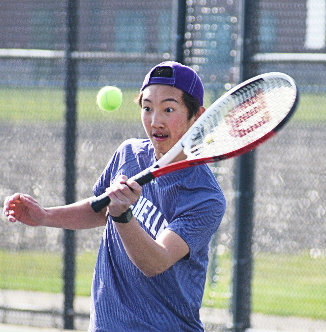 Sophomore Evin Odle hits a forehand shot for the Rochelle Hub varsity tennis team. (Photo by Russell Hodges)