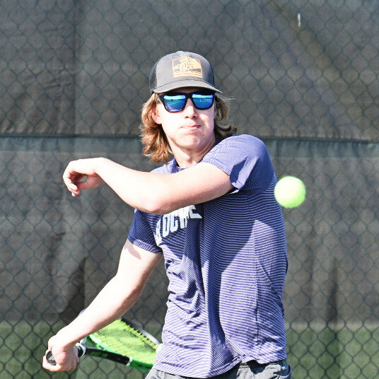 Sophomore David Wanner hits a return shot during the Rochelle Hub tennis match against Belvidere North on Thursday. (Photo by Russell Hodges)