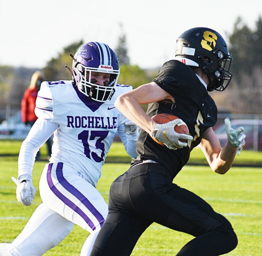Senior Spencer Warborg tracks down Sycamore's Bailey Wiegmann during the Rochelle Hub varsity football game against the Spartans on Friday. (Photo by Russell Hodges)