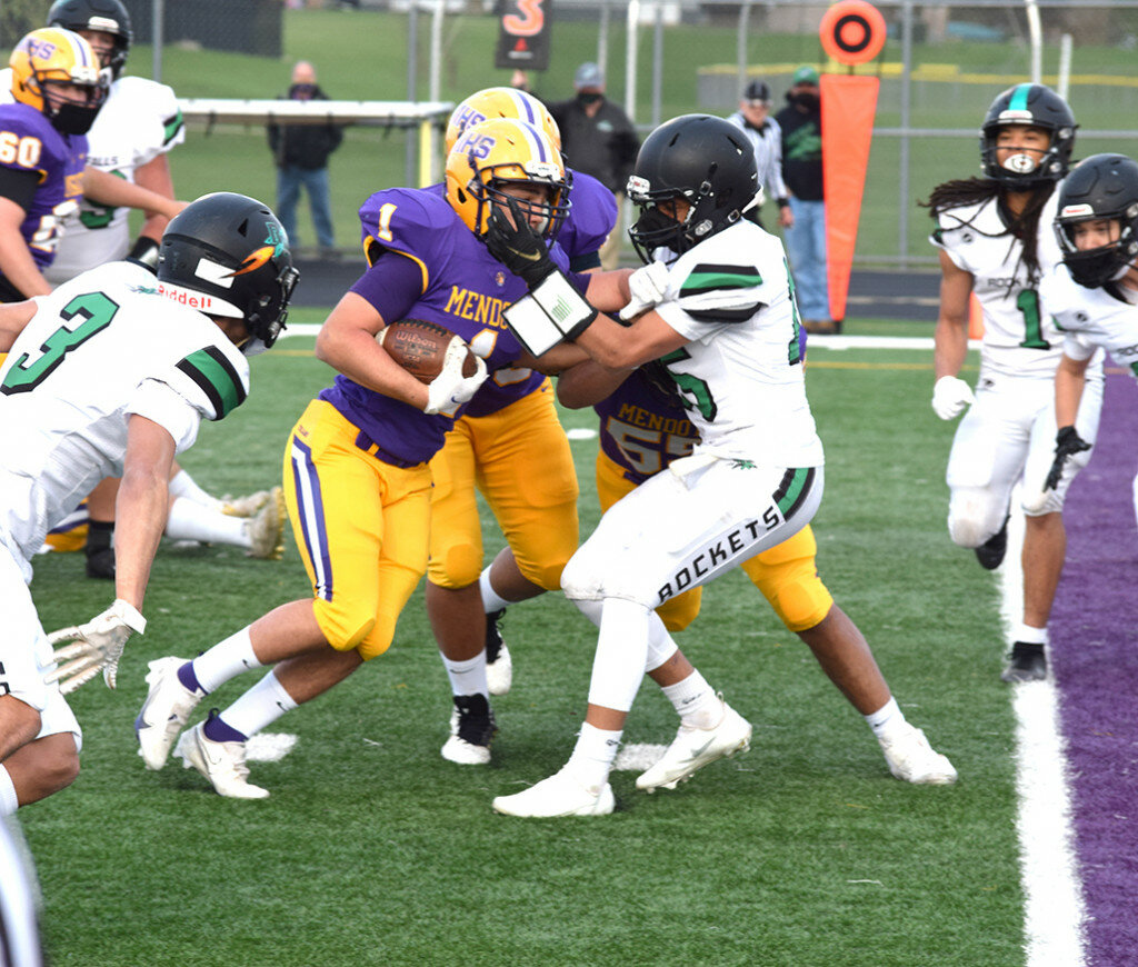 Mendota’s Damien Magallanes churns his way toward the goal line as Rock Falls’ Baraka Boards tries to prevent him from reaching the end zone on April 9 at the MHS field. Magallanes scored on the play and added three more rushing touchdowns in Mendota’s win. (Reporter photo)