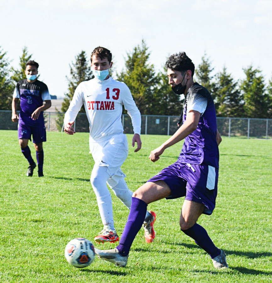 Senior Damian Salinas passes the ball up the field during the Rochelle Hub varsity soccer match against Ottawa on Monday. (Photo by Russell Hodges)