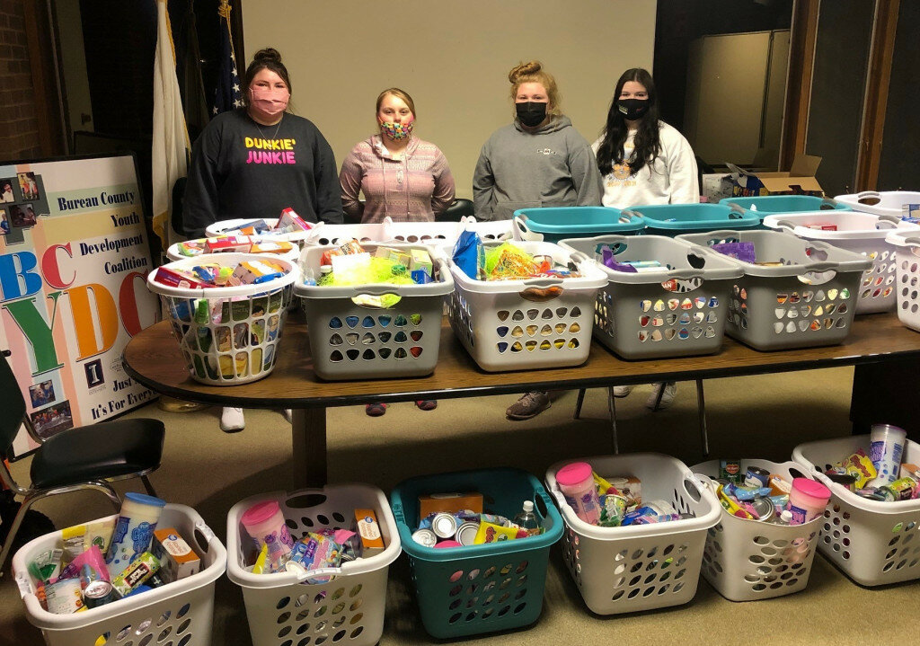 Federation members, left to right, Ryley Aukes, Haven Pierson, Katrina Wahl and Jennifer Dunlap display Easter baskets that were donated to Bureau County families. (Photo contributed)