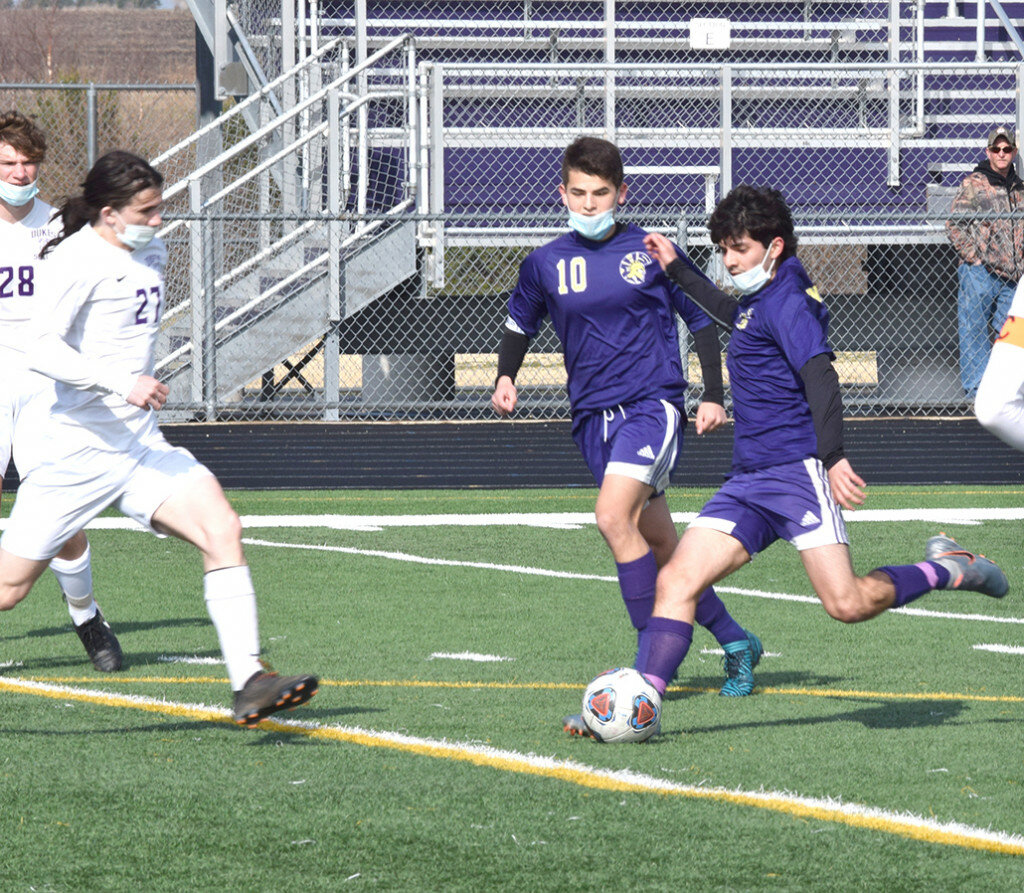 Mendota’s Jose Ruiz gets ready to deliver shot on goal as Dixon’s Ethan Fox moves in to defend on March 27 at the MHS field. (Reporter photo)