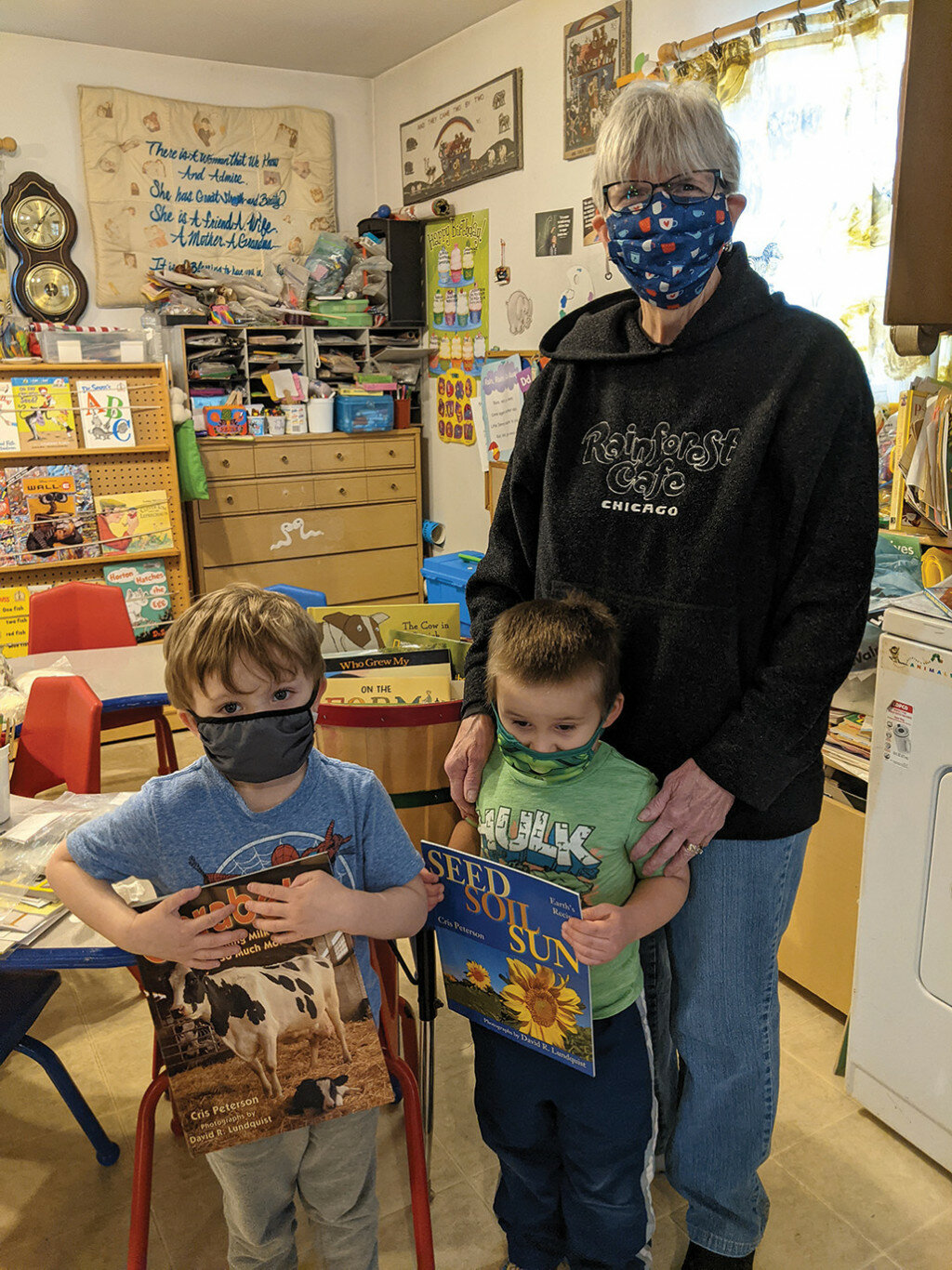 Kids Under Construction Daycare accepts the Books by the Bushel donation from the Lee County Farm Bureau Foundation.  Pictured are Liam Loomis, Spencer Nelson and Marjorie Redcliff. 
Photo submitted