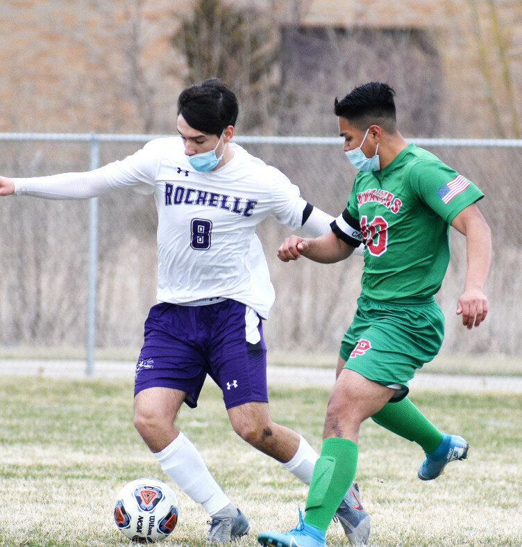 Senior Zane Walters battles for possession during the Rochelle Hub varsity soccer match against LaSalle-Peru on Wednesday. (Photo by Russell Hodges)